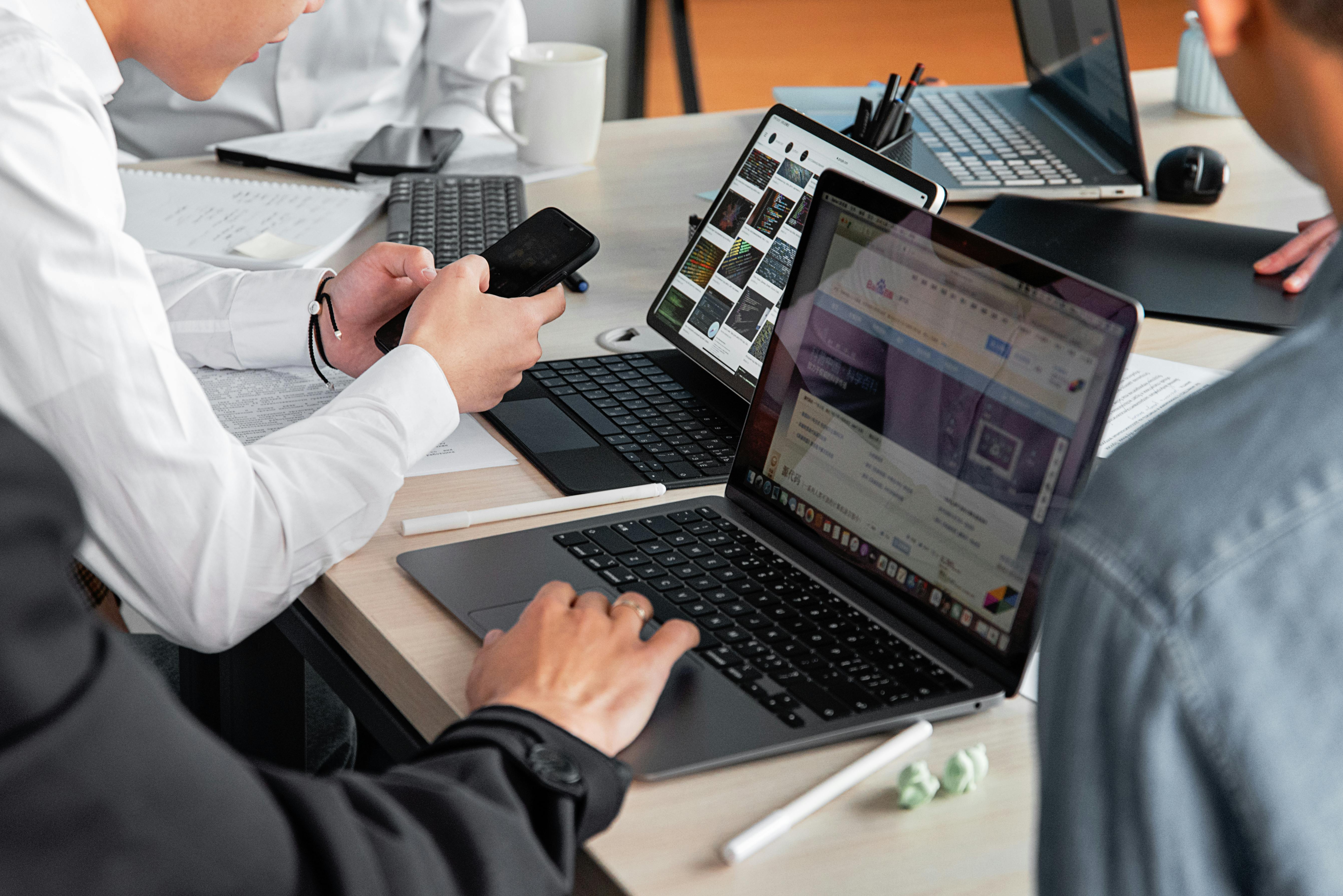 Offshore technical team collaborating around laptops
